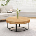 Table basse ronde en pin sculpté avec piètement en anneau en métal noir