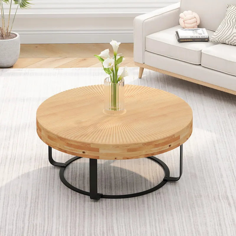 Table basse ronde en pin sculpté avec piètement en anneau en métal noir